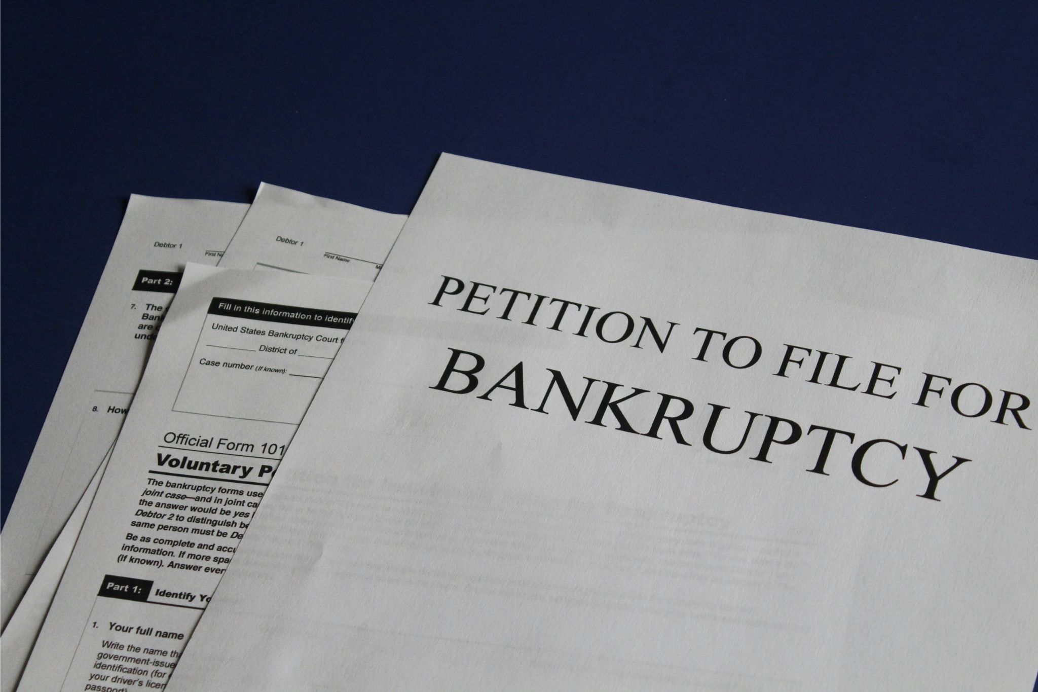 Official petition documents for filing bankruptcy, including forms for voluntary petitions under Chapter 7 and Chapter 13 bankruptcy, showing the legal paperwork involved in seeking debt discharge, financial relief, and protection from creditors through the bankruptcy court system.